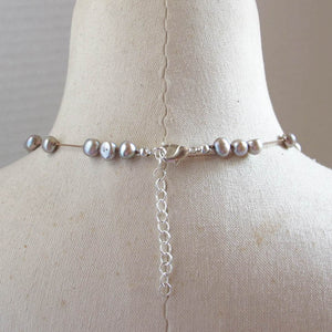 Floating Design Dove Gray Freshwater Pearl Necklace on beige silk cord with silver lobster claw clasp and silver extender chain
