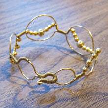 Load image into Gallery viewer, Bead wrapped wire bracelet with matching metal beads, goldtone