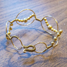 Load image into Gallery viewer, Bead wrapped wire bracelet with matching metal beads, goldtone