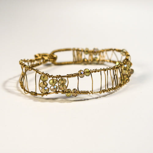 Gold hand-shaped wire bracelet with crystal beads
