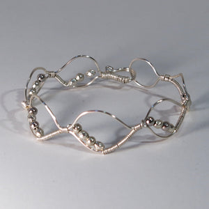 Silver hand-shaped wire bracelet with matching beads
