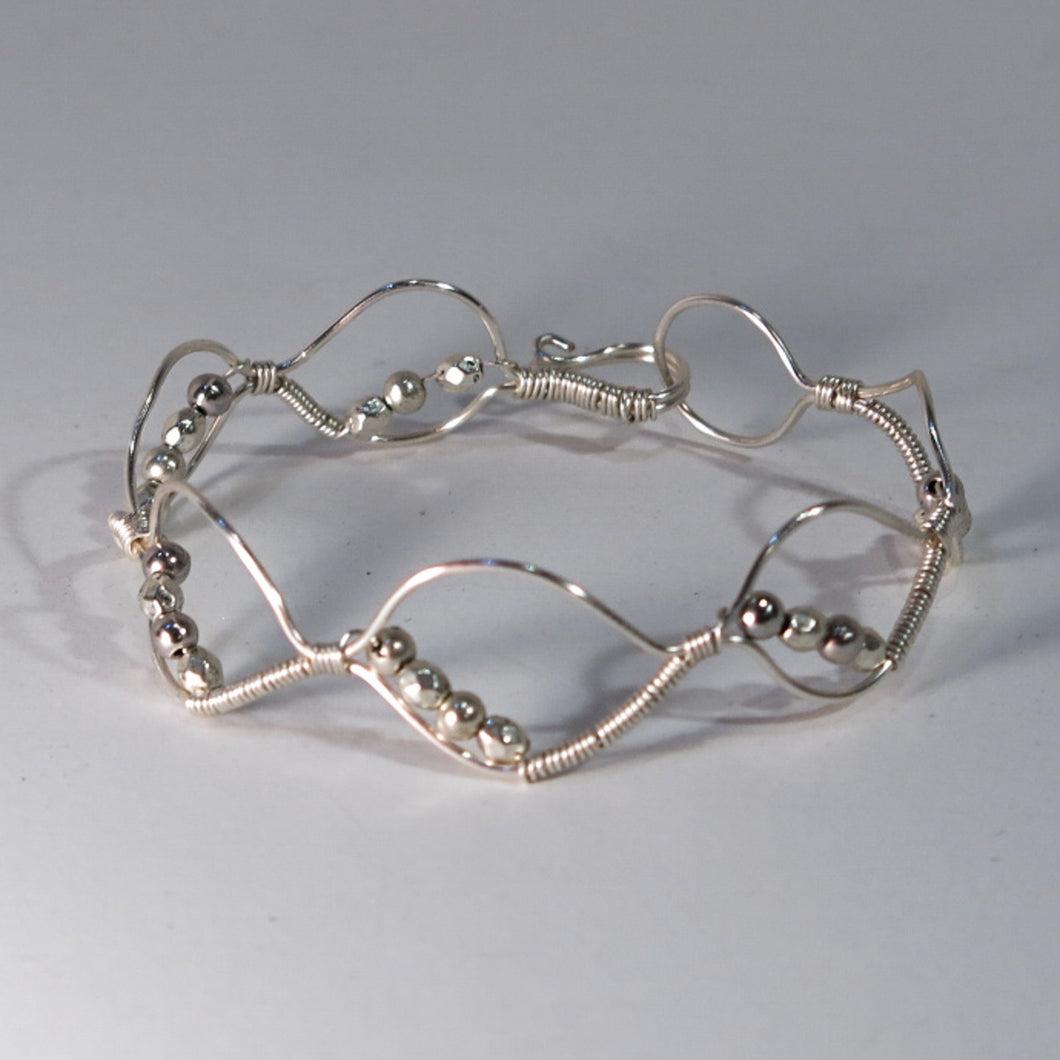Silver hand-shaped wire bracelet with matching beads