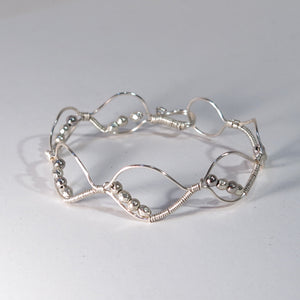 Silver hand-shaped wire bracelet with matching beads