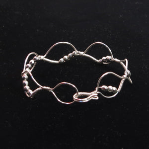 Silver hand-shaped wire bracelet with matching beads