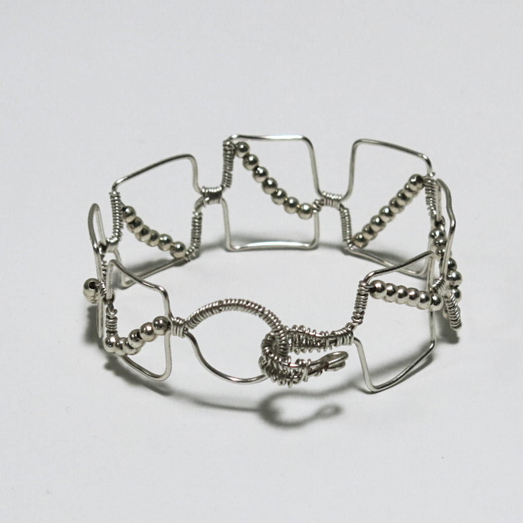 Silver hand-shaped wire bracelet with matching beads