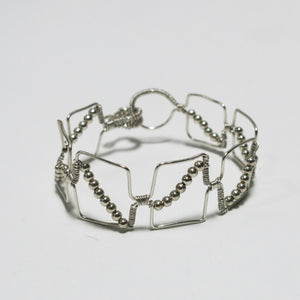 Silver hand-shaped wire bracelet with matching beads