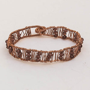 Copper hand-shaped wire bracelet with crystal beads