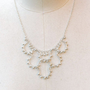 Mini Wire Loop Necklace on silver chain wrapped with matching metal beads